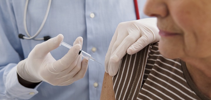 An older person receives an injection. Flu vaccine